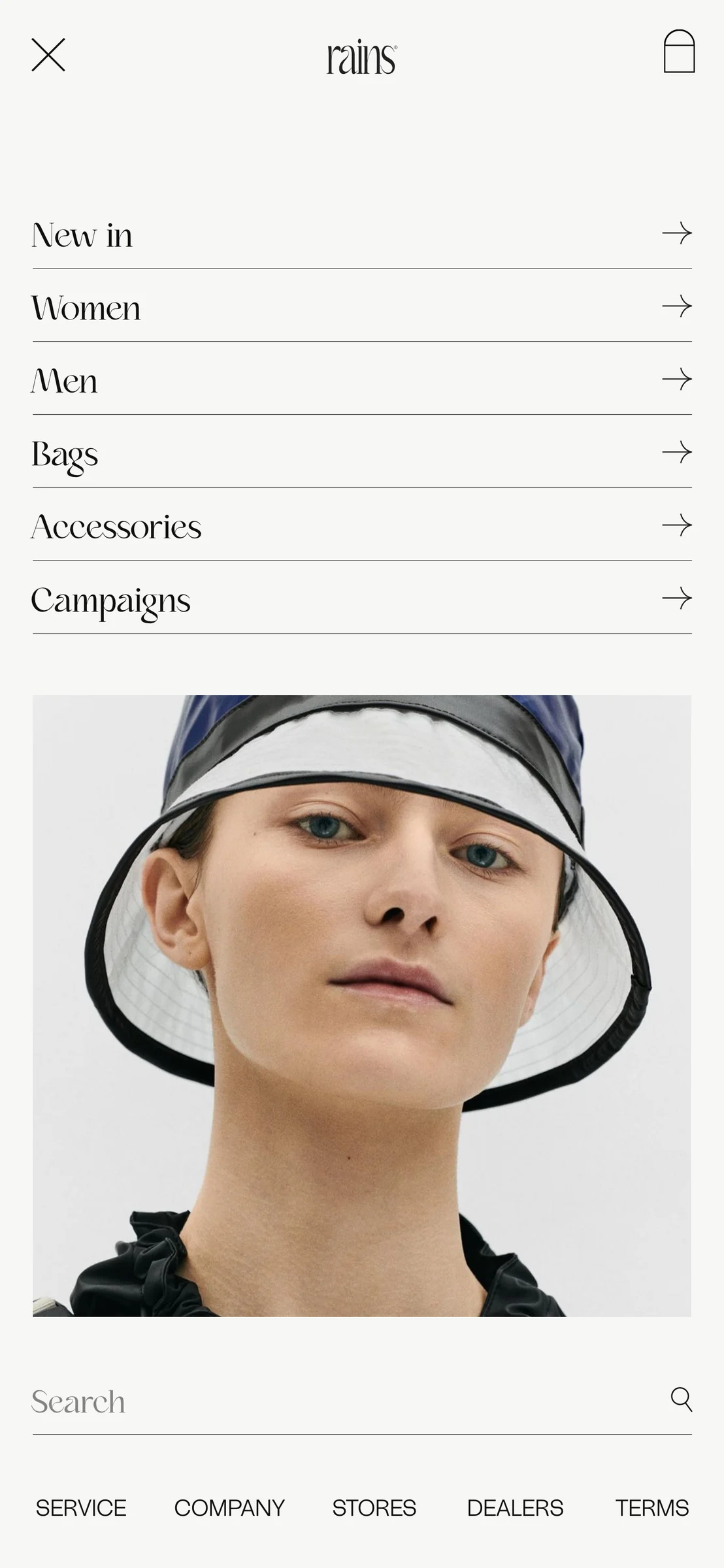 Mobile menu screen with category links, model in a black and white bucket hat and a search bar, for Rains.