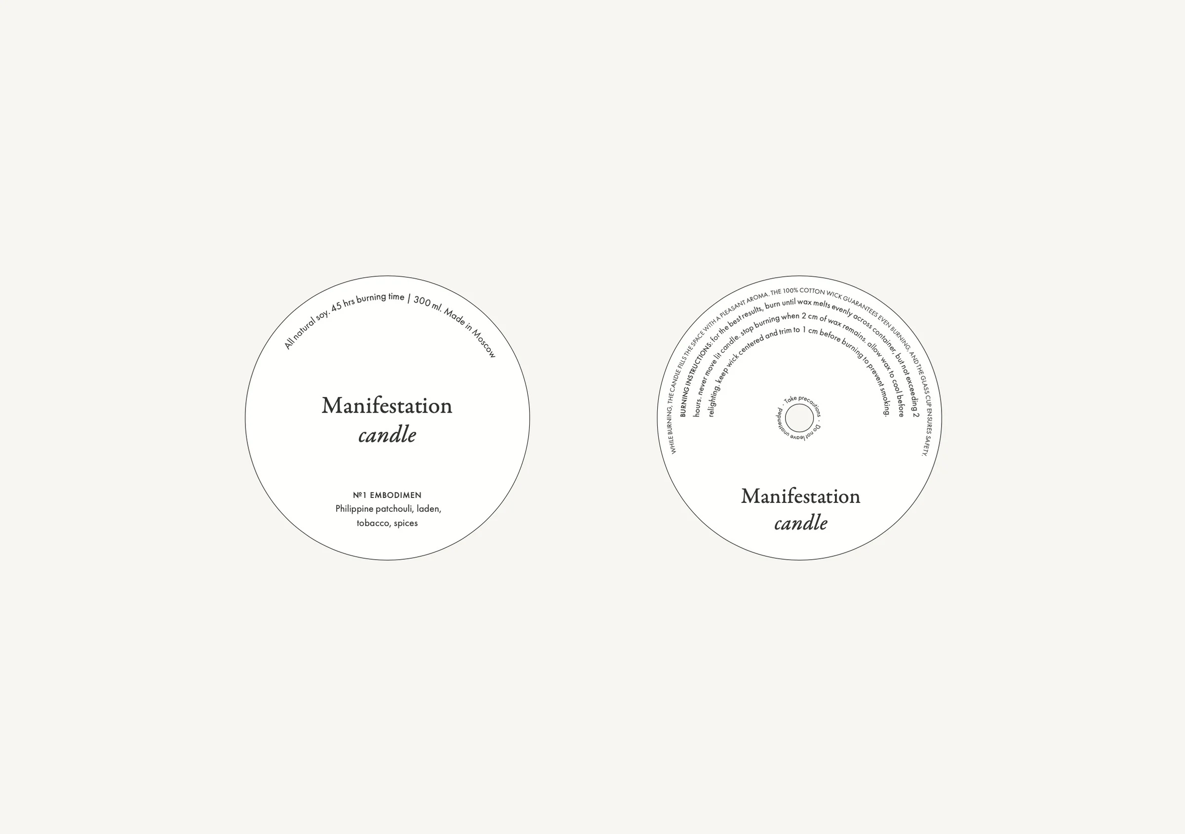 Two round white candle labels, front and back, with serif Manifestation candle type and scent notes, for Manifestation.