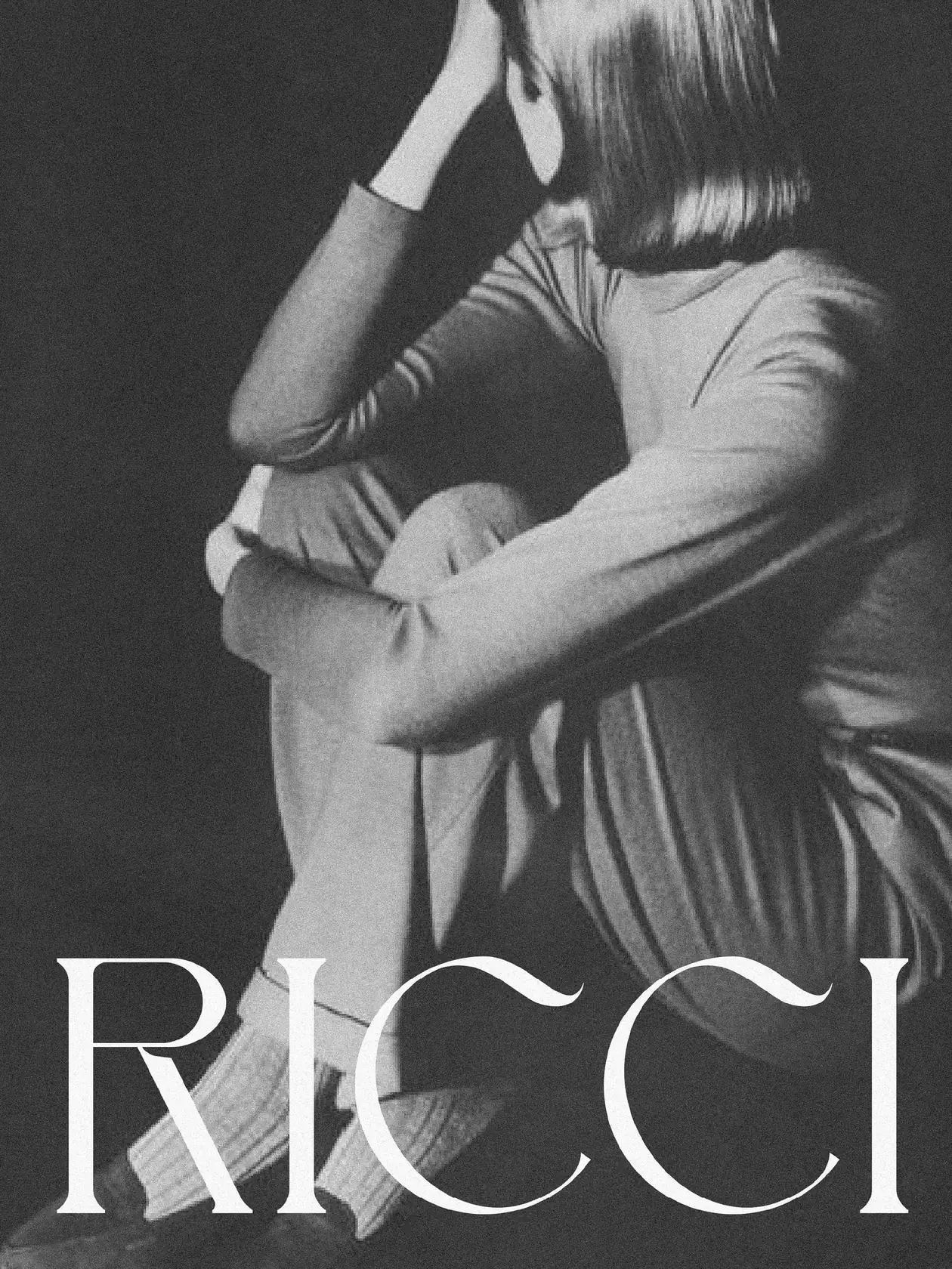 Black-and-white poster of a seated woman hugging her knees in loungewear, white RICCI wordmark across the bottom, for Ricci.