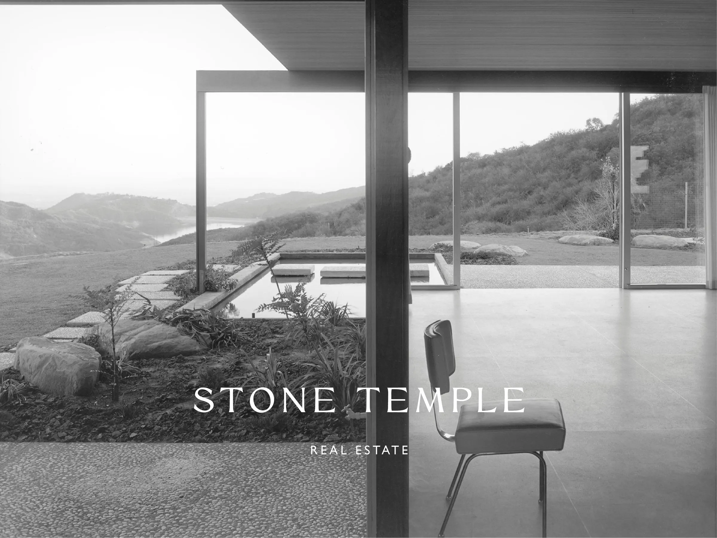 White wordmark over a black-and-white photo of a modernist glass house with a chair, reflecting pool and hills, for Stone Temple.