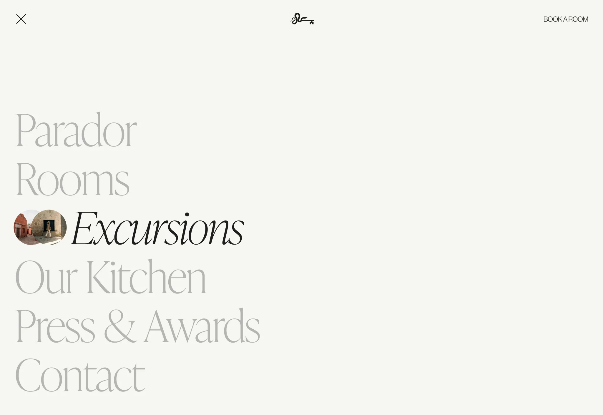Website menu listing Parador, Rooms, Excursions, Our Kitchen, Press & Awards and Contact on cream, for Cirqa.